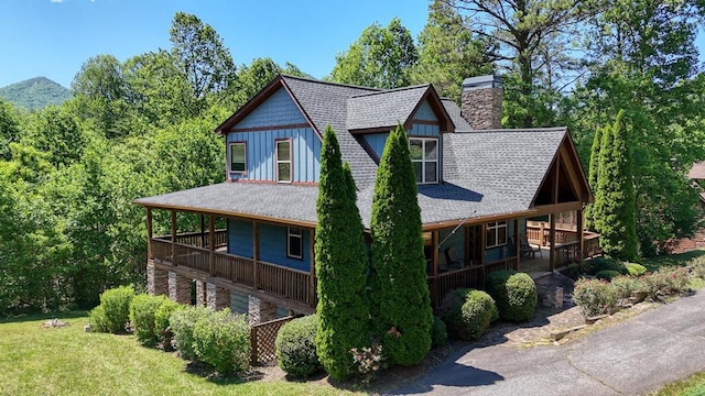602 Mill Ridge Rd, Hiawassee, GA 30546 - view of property exterior featuring roof with shingles, a chimney, covered porch, and board and batten siding
