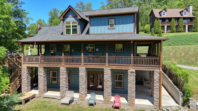 602 Mill Ridge Rd, Hiawassee, GA 30546 - view of front of house with board and batten siding, a front lawn, a patio, roof with shingles, and a chimney