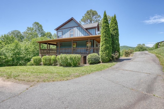 602 Mill Ridge Rd, Hiawassee, GA 30546 - view of front facade featuring board and batten siding, covered porch, and a front yard
