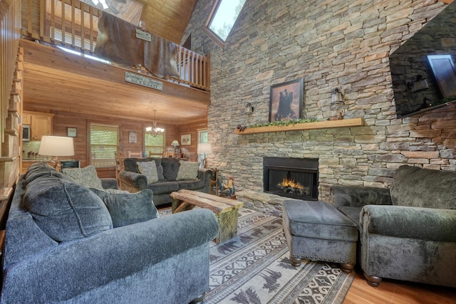 602 Mill Ridge Rd, Hiawassee, GA 30546 - living room featuring a chandelier, wood finished floors, a high ceiling, a stone fireplace, and wood ceiling