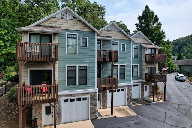 view of front facade featuring a garage and a balcony