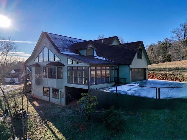 back of house featuring a sunroom