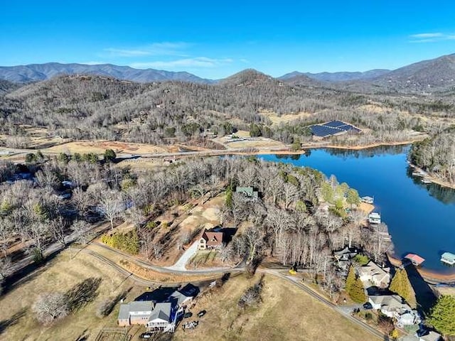 drone / aerial view featuring a water and mountain view