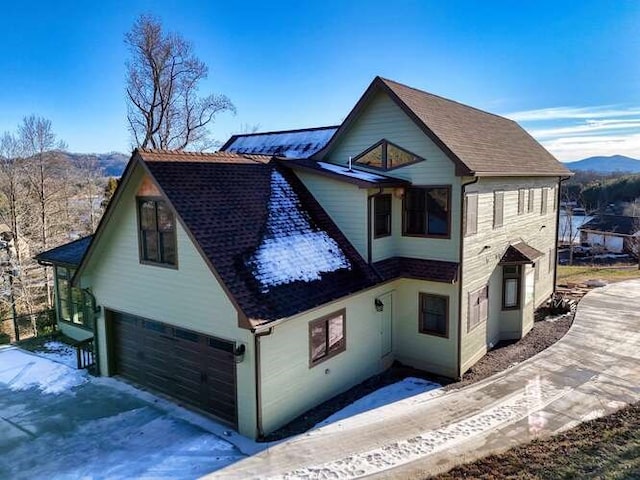 view of front of house featuring a garage and a mountain view