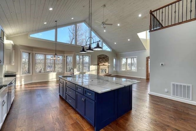 kitchen featuring white cabinetry, dark hardwood / wood-style flooring, ceiling fan, blue cabinetry, and wooden ceiling