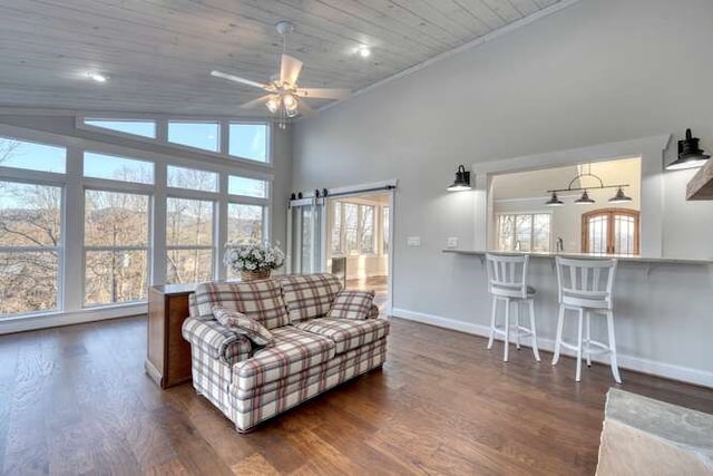 living room with dark hardwood / wood-style flooring, plenty of natural light, wooden ceiling, and a barn door