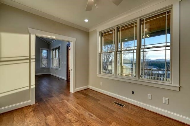 spare room with ceiling fan, ornamental molding, and hardwood / wood-style floors