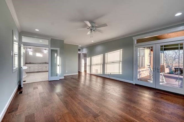 unfurnished living room featuring crown molding, ceiling fan, dark hardwood / wood-style flooring, and french doors