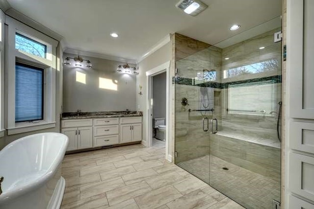 full bathroom with crown molding, vanity, toilet, and plus walk in shower