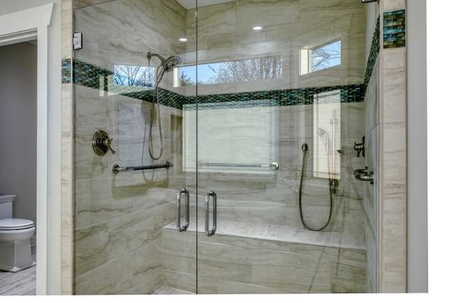 bathroom featuring toilet and walk in shower