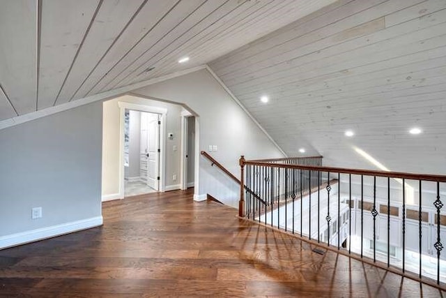 additional living space with hardwood / wood-style flooring, vaulted ceiling, and wooden ceiling