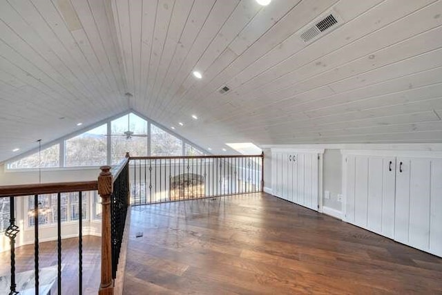 additional living space featuring wood ceiling, dark wood-type flooring, ceiling fan, and vaulted ceiling