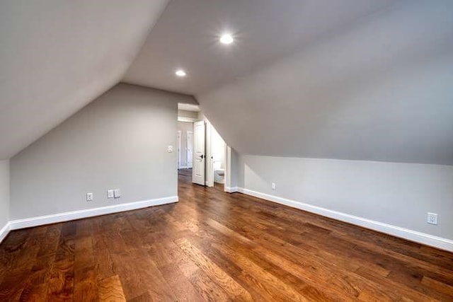 bonus room featuring dark wood-type flooring and vaulted ceiling