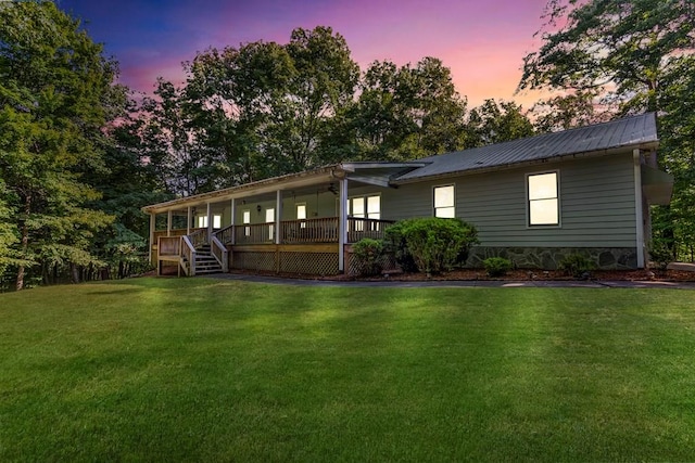 view of front of property featuring a yard and a deck