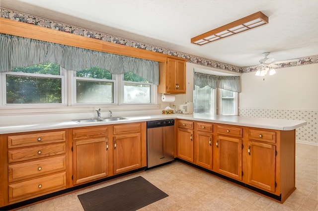 kitchen featuring plenty of natural light, kitchen peninsula, stainless steel dishwasher, and ceiling fan