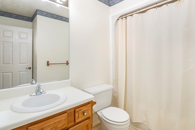 bathroom featuring vanity, toilet, and a shower with shower curtain