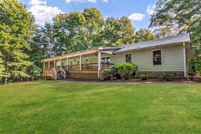 view of front of property featuring a front lawn and a wooden deck