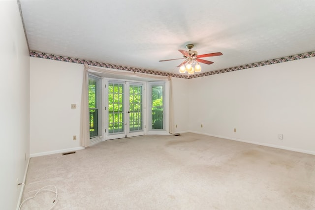 carpeted empty room with a textured ceiling and ceiling fan