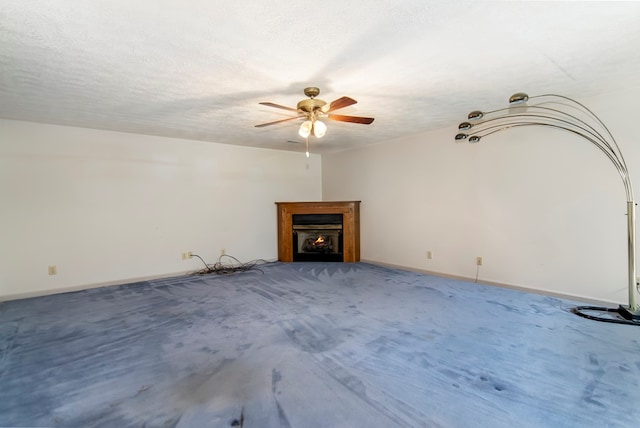 unfurnished living room with a textured ceiling, ceiling fan, and carpet flooring