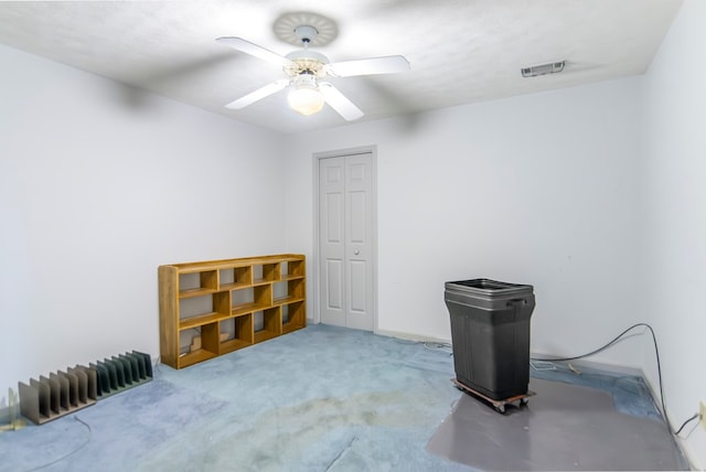 interior space featuring a textured ceiling, ceiling fan, and carpet flooring