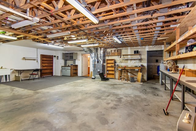 garage featuring a workshop area and heating unit