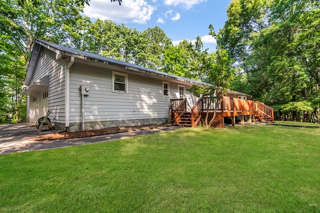 back of house with a yard and a deck