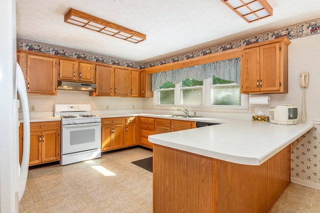 kitchen featuring white appliances, kitchen peninsula, sink, and a textured ceiling