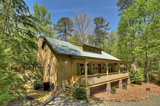 rear view of property with covered porch