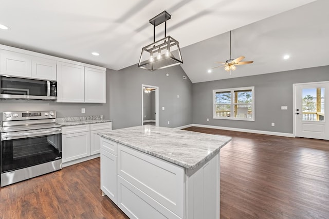 kitchen featuring plenty of natural light, light stone countertops, white cabinets, and appliances with stainless steel finishes