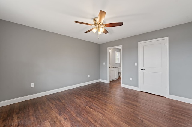 unfurnished bedroom with ceiling fan, connected bathroom, and dark hardwood / wood-style flooring