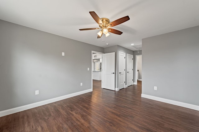 unfurnished room featuring dark wood-type flooring and ceiling fan