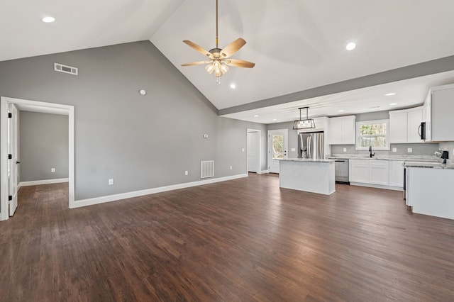 kitchen featuring a kitchen island, dark hardwood / wood-style floors, decorative light fixtures, white cabinets, and stainless steel appliances