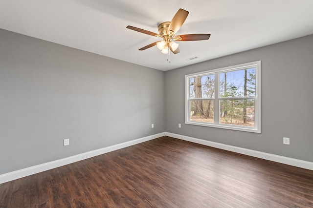 spare room featuring dark hardwood / wood-style floors and ceiling fan