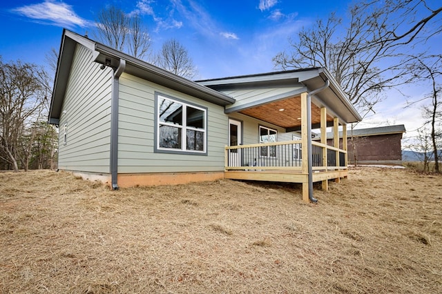 rear view of property with a wooden deck