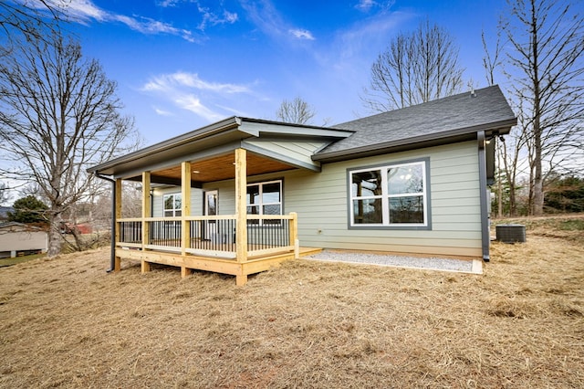 rear view of property featuring central AC unit and a porch