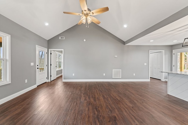 unfurnished living room with vaulted ceiling, dark hardwood / wood-style floors, and ceiling fan