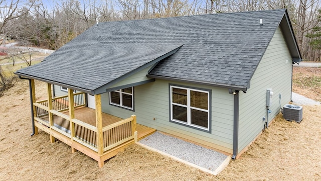 rear view of house with a deck and central air condition unit