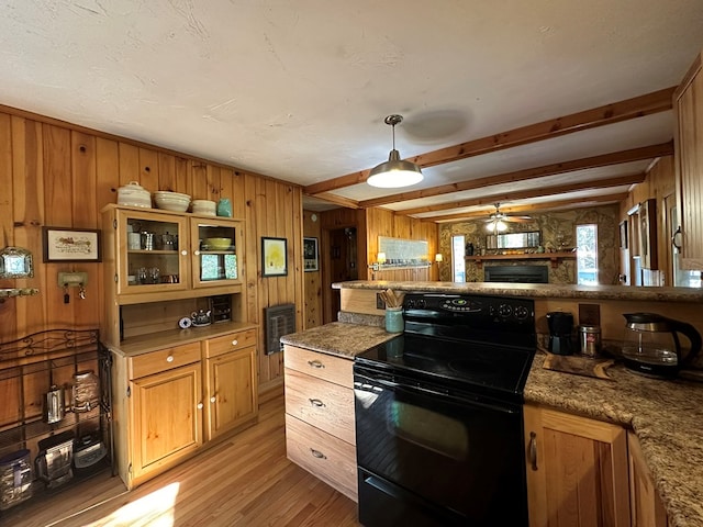 kitchen with beam ceiling, electric range, hanging light fixtures, light wood-type flooring, and wooden walls