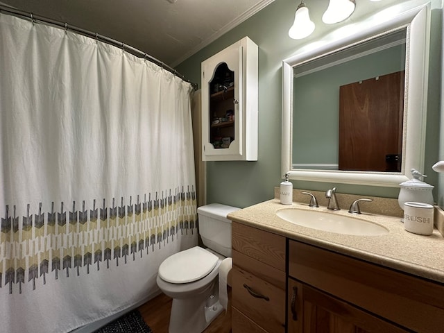 bathroom with wood finished floors, vanity, a shower with curtain, toilet, and ornamental molding