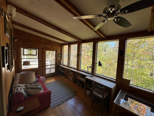 sunroom / solarium with french doors, vaulted ceiling with beams, wood finished floors, and wooden walls