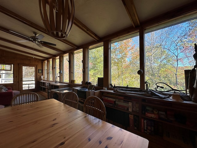 dining area with a ceiling fan and vaulted ceiling with beams