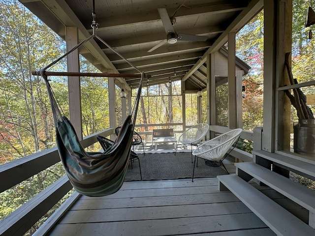 sunroom / solarium featuring ceiling fan