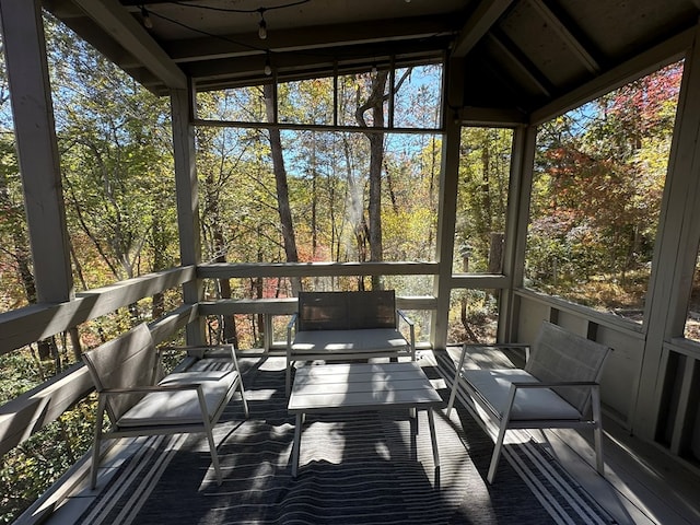 sunroom / solarium featuring a wealth of natural light and vaulted ceiling