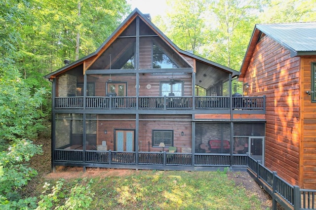 rear view of property featuring a sunroom