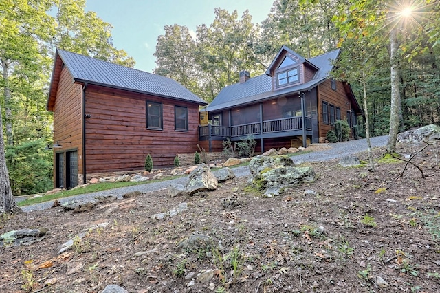 back of property with a sunroom