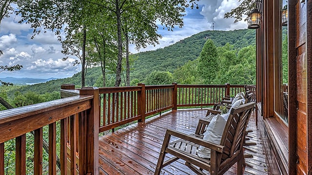 wooden deck with a mountain view