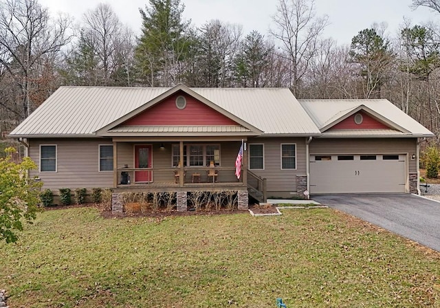 view of front of property with driveway, a garage, metal roof, a porch, and a front yard