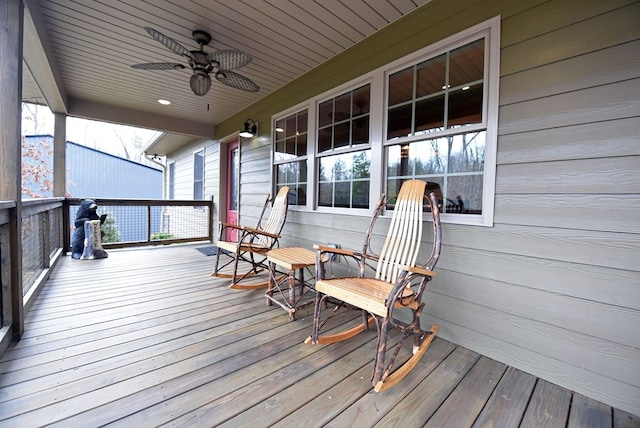 wooden deck featuring covered porch and ceiling fan