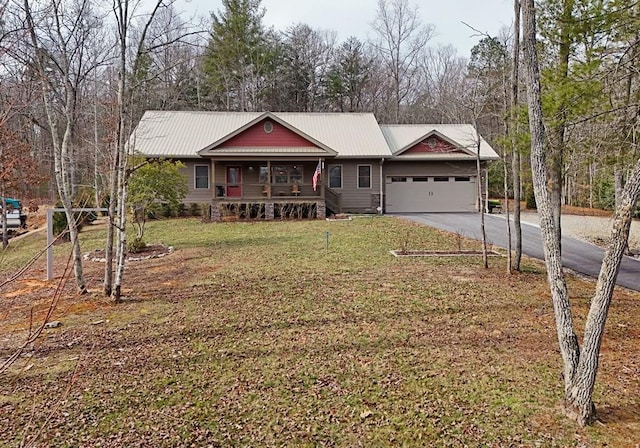 view of front of home with an attached garage, metal roof, driveway, and a porch