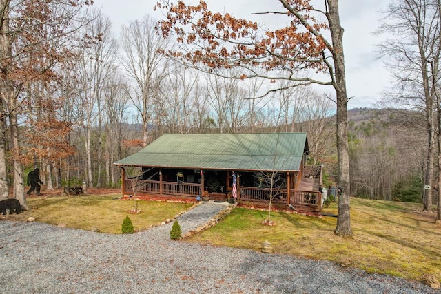 view of front facade with a front yard and covered porch